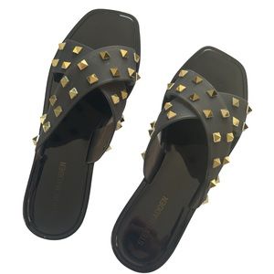 black flat sandals with gold appliqués to be inside and outside the house
